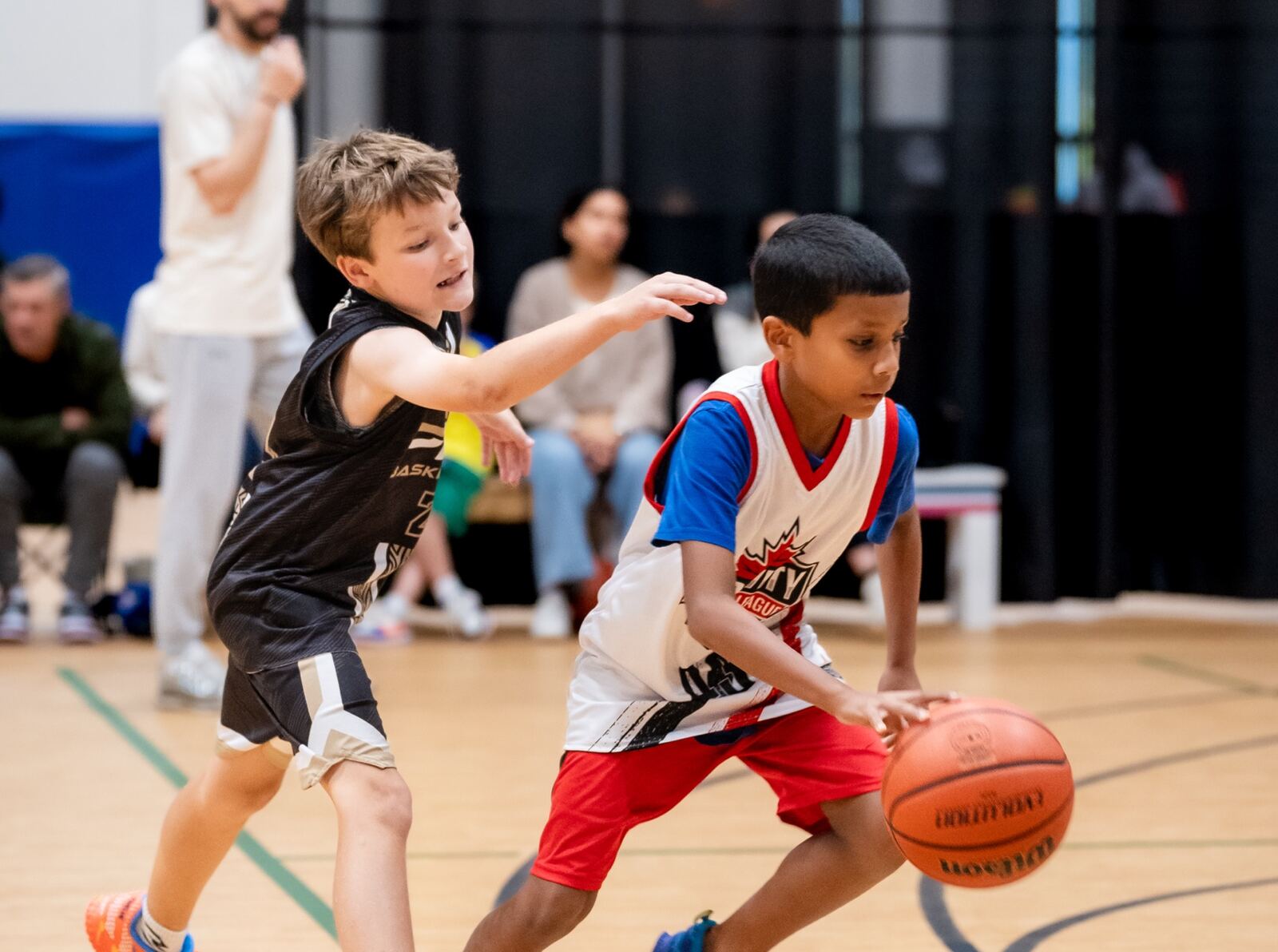 Two young players going for the ball during a house league game